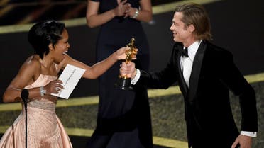 Regina King (left), presents Brad Pitt with the award for best performance by an actor in a supporting role for “Once Upon a Time in Hollywood” at the Oscars on February 9, 2020, at the Dolby Theatre in Los Angeles. (AP)