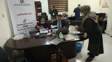 Employees of the Central Elections Commission prepare documents at the Commission’s office in Gaza City on March 20, 2021, at the start of the registration period for the May parliamentary election.  (Mohammed Abed/AFP)