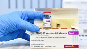 A healthcare worker shows a vial and a box of the AstraZeneca coronavirus disease (COVID-19) vaccine, as vaccinations resume after a brief pause in their use over concern for possible connection to blood clots, in Turin, Italy, March 19, 2021. (Reuters)