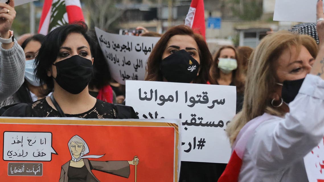 Lebanese women hold placards protesting against the country’s deep economic crisis in Beirut on the occasion of Mother’s Day on March 20, 2021. (File photo: AFP)