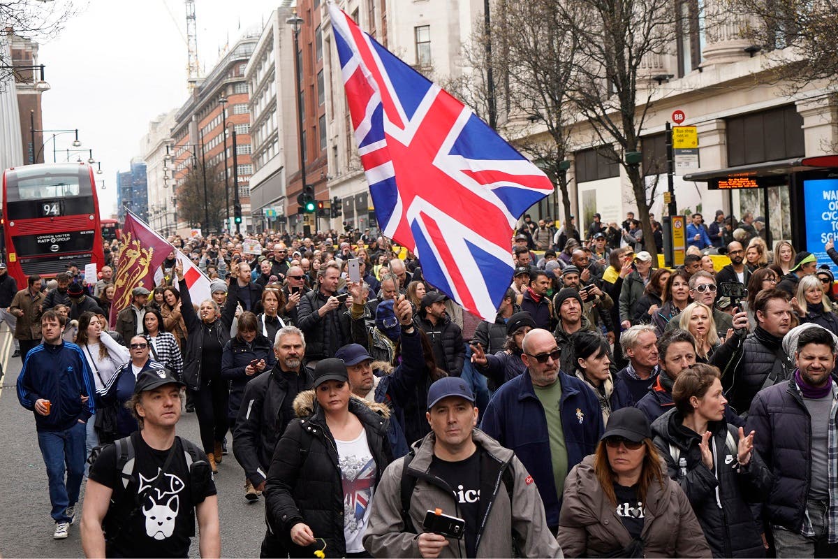  Demonstrators march against the ongoing coronavirus restrictions during an anti-lockdown protest in central London on March 20, 2021. (Niklas Halle’N/AFP)