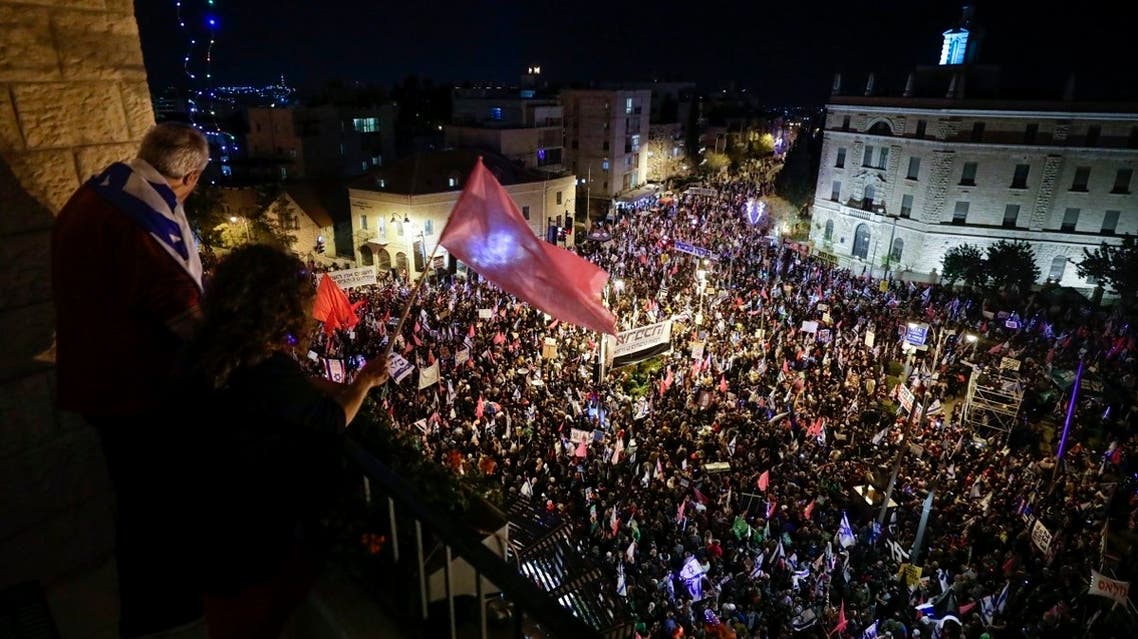 Thousands of protesters chant slogans and hold signs during a protest against Israel's Prime Minister Benjamin Netanyahu outside his residence in Jerusalem, on March. 20, 2021. (AP)