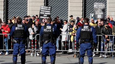 A file photo shows protestors facing police officers as they stage a rally in Bern on October 31, 2020, against new coronavirus measures. (Stefan Wermuth/AFP)