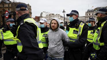 Police officers detain a person during a protest against the lockdown, amid the spread of the coronavirus, in London, Britain March 20, 2021. (Reuters/Henry Nicholls)