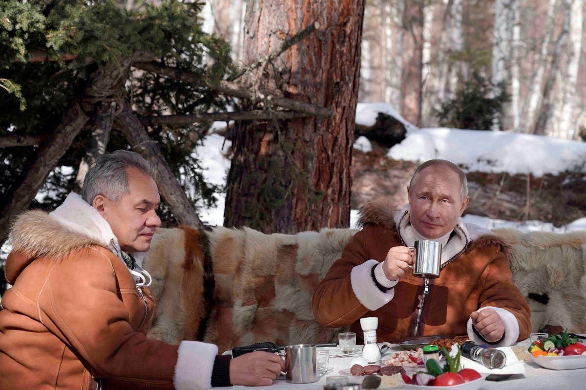 Russian President Vladimir Putin, right, and Russian Defense Minister Sergei Shoigu have a meal and drinks in a taiga forest in Russia’s Siberian region in Russia, Sunday, March 21, 2021. (Alexei Druzhinin, Sputnik, Kremlin Pool Photo via AP)