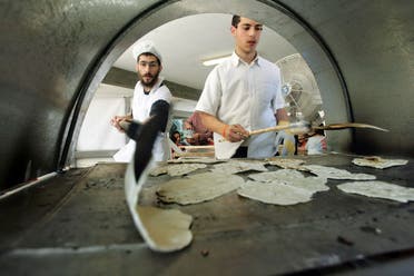 Ultra-Orthodox Jewish settlers prepare Matzah bread, traditional handmade Passover unleavened bread, in the Jewish settlement of Neve Dekalim in the Gush Katif settlement block in the Gaza Strip Monday, April 11, 2005. (AP)