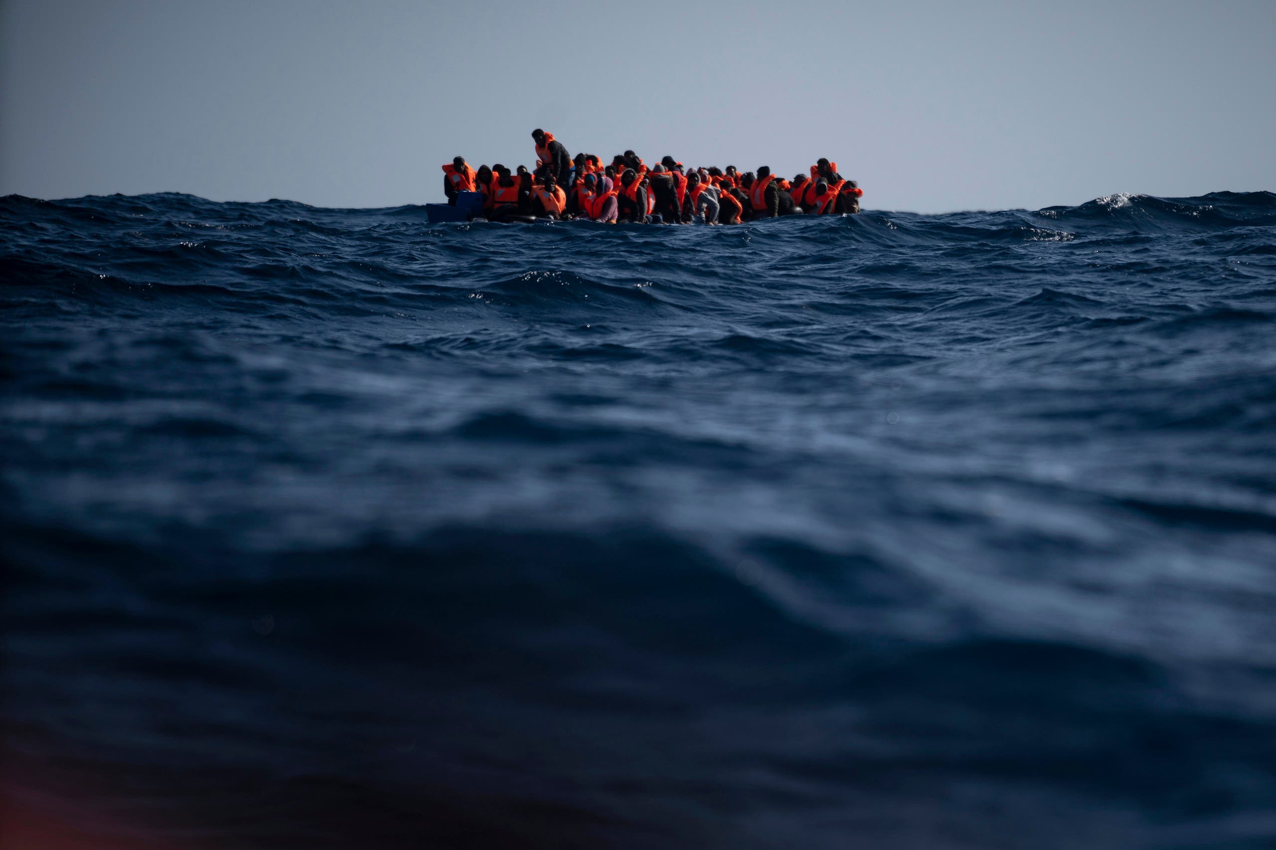 Migrants from Eritrea, Egypt, Syria and Sudan, wait to be assisted by aid workers of the Spanish NGO Open Arms, after fleeing Libya on board a precarious wooden boat in the Mediterranean sea, about 110 miles north of Libya. (File photo: AP)