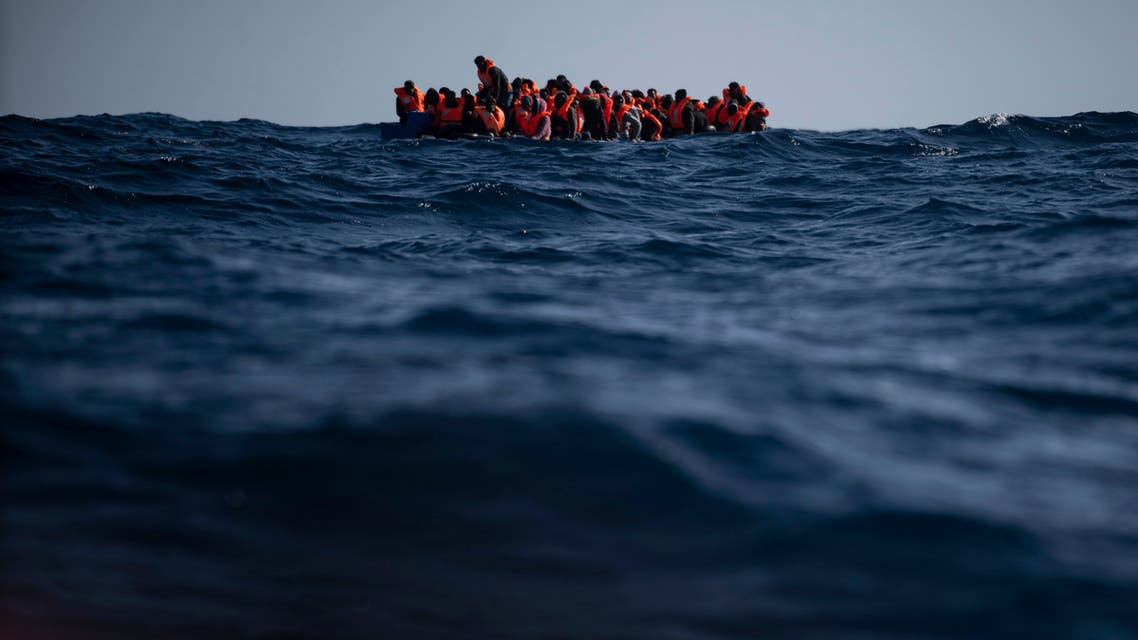 Migrants from Eritrea, Egypt, Syria and Sudan, wait to be assisted by aid workers of the Spanish NGO Open Arms, after fleeing Libya on board a precarious wooden boat in the Mediterranean sea, about 110 miles north of Libya. (File photo: AP)