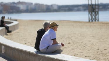 Tourists sit next to the sea in Playa de Palma beach in Palma de Mallorca on March 22, 2021. (File photo: Reuters)
