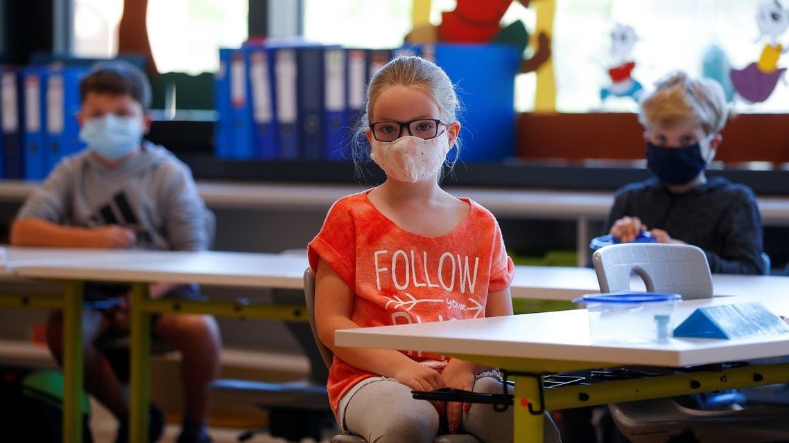 Children wearing protective face masks sit in a classroom at a primary school, as Austrian schools reopen for pupils aged roughly six to 14, during the global coronavirus disease (COVID-19) outbreak, in Brunn am Gebirge, Austria. (Reuters)