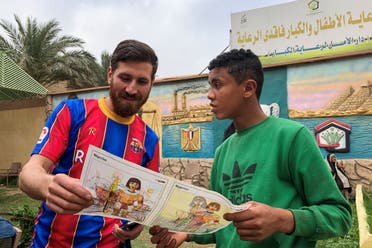 Islam Mohammed Ibrahim Battah, an Egyptian with a striking resemblance to BarcelonaÕs forward Lionel Messi, is seen with a youth in a club training facility, in the Nile Delta city of Zagazig, north of Cairo, Egypt March 23, 2021. (Reuters)