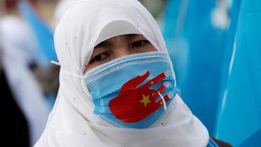 An Ethnic Uighur demonstrator wearing a protective face mask to prevent the spread of the coronavirus disease (COVID-19), takes part in a gathering on the occasion of International Women's Day to protest China's treatment of Uighurs, in Istanbul, Turkey March 8, 2021. (File photo: Reuters)