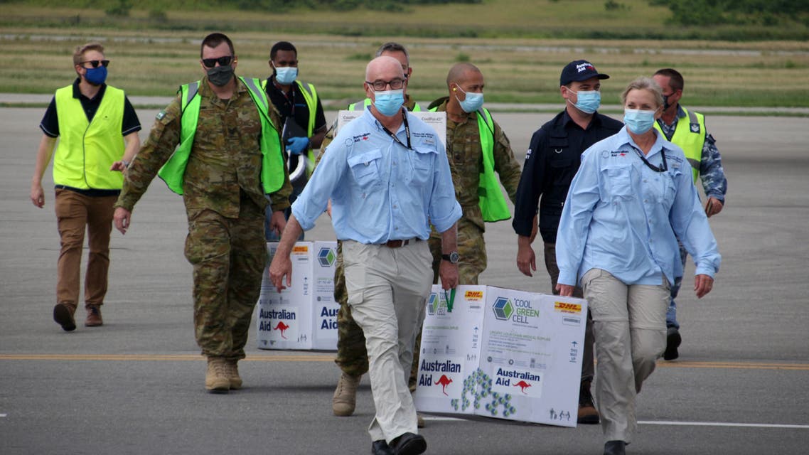 Australian officials carry boxes containing some 8,000 initial doses of the AstraZeneca vaccine following their arrival on board a Royal Australian Air Force plane at the Port Moresby international airport on March 23, 2021, as Papua New Guinea raced to quell a Covid-19 surge overwhelming its fragile health system. (File photo: AFP)
