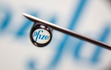 Pfizer logo is reflected in a drop on a syringe needle in this illustration photo taken March 16, 2021. (Reuters)