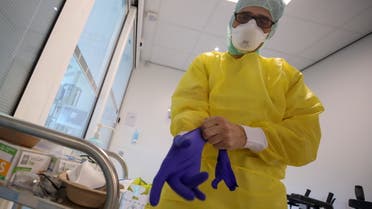A member of the medical personnel prepares to work with patients suffering from the coronavirus disease (COVID-19) at the intensive care unit at CHIREC Delta Hospital in Brussels, Belgium, March 24, 2021. (Reuters)