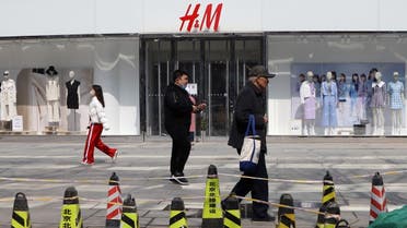 People walk past a store of the Swedish fashion retailer H&M at a shopping complex in Beijing, China March 25, 2021. (Reuters)