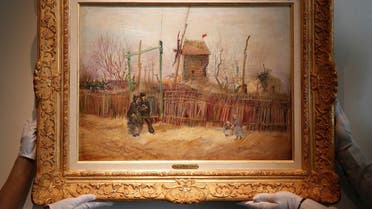 otheby’s personnel display ‘Scene de rue à Montmartre’ (Street scene in Montmartre), a painting by Dutch master Vincent van Gogh at Sotheby’s auction house in Paris. (AP)