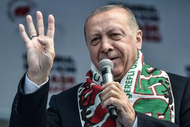 Turkish President Recep Tayyip Erdogan flashes four fingers and makes the Rabia sign as he speaks during a pre-election rally at Bayrampasa district in Istanbul, on March 30, 2019. (AFP)