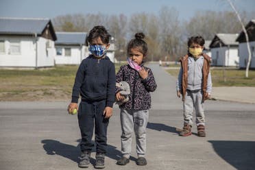 Children wear protective face masks in a camp for refugees and migrants as Serbia begins vaccinating migrants against the coronavirus disease (COVID-19), Belgrade, Serbia, March 26, 2021. (Reuters)