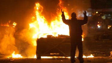 A protester reacts near burning police cars in central Yerevan March 2, 2008. (Reuters)