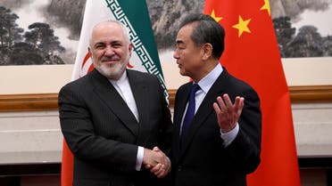 China’s Foreign Minister Wang Yi shakes hands with Iran’s Foreign Minister Mohammad Javad Zarif during a meeting at the Diaoyutai state guest house in Beijing, China, on December 31, 2019. (Reuters)