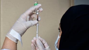A medical worker prepares a dose of the AstraZeneca COVID-19 vaccine at the first drive-through vaccination center in the Saudi capital Riyadh, on March 4, 2021.