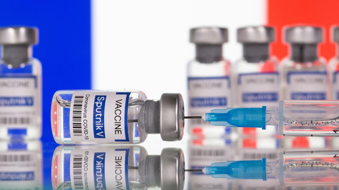 Vials labelled Sputnik V Coronavirus COVID-19 Vaccine and a syringe are seen in front of a displayed French flag, in this illustration photo taken March 12, 2021. REUTERS/Dado Ruvic/Illustration