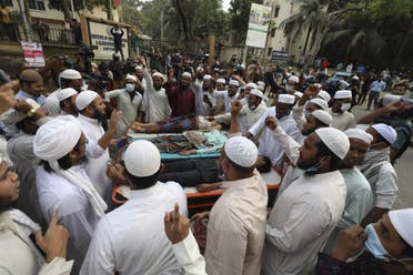 Activists of the Hifazat-e Islam group shout slogans next to the dead bodies of other activists outside the Chittagong medical college hospital in Chittagong on March 26, 2021 following clashes with police during a demonstration against Indian Prime minister Narendra Modi's visit to Bangladesh. (AFP)