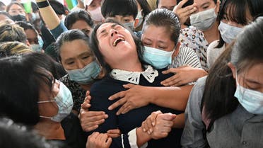 The mother (C) of Khant Nyar Hein reacts at his funeral in Yangon on March 16, 2021, after the first year medical student was shot dead during a crackdown by security forces on protesters taking part in a demonstration against the military coup.
