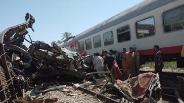 People inspect the damage after two trains have collided near the city of Sohag. (Reuters)