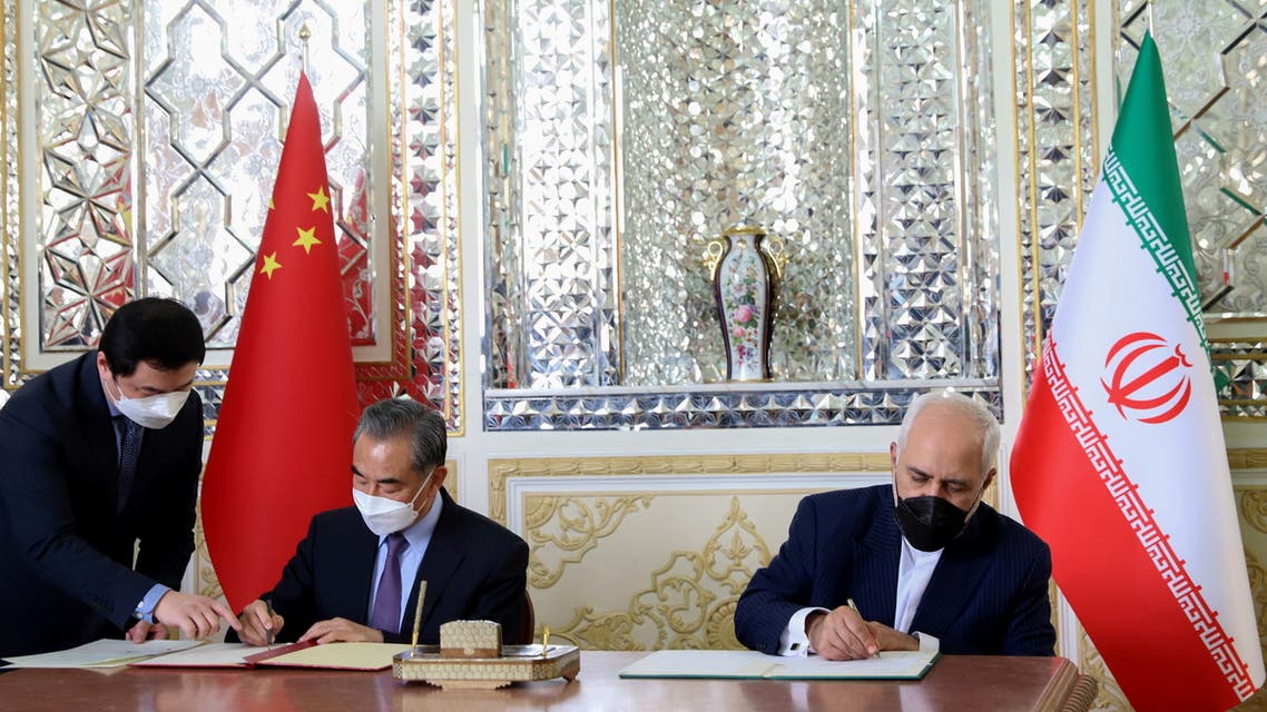 Iran's Foreign Minister Mohammad Javad Zarif and China's Foreign Minister Wang Yi bump elbows during the signing ceremony of a 25-year cooperation agreement, in Tehran, Iran March 27, 2021. Majid Asgaripour/WANA (West Asia News Agency) via REUTERS ATTENTION EDITORS - THIS IMAGE HAS BEEN SUPPLIED BY A THIRD PARTY.