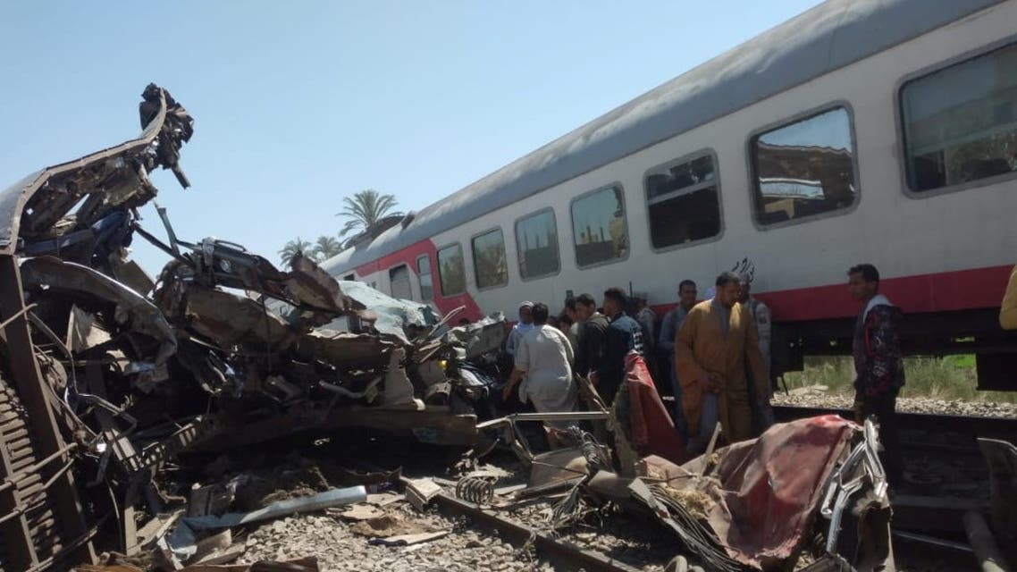 People inspect the damage after two trains collided near the city of Sohag, Egypt, March 26, 2021. REUTERS/Khaled Hasan NO RESALES. NO ARCHIVES