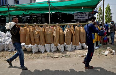 Election workers carry bags of election material at a distribution centre ahead of the first phase of West Bengal state assembly election, in Purulia district, India. (Reuters)