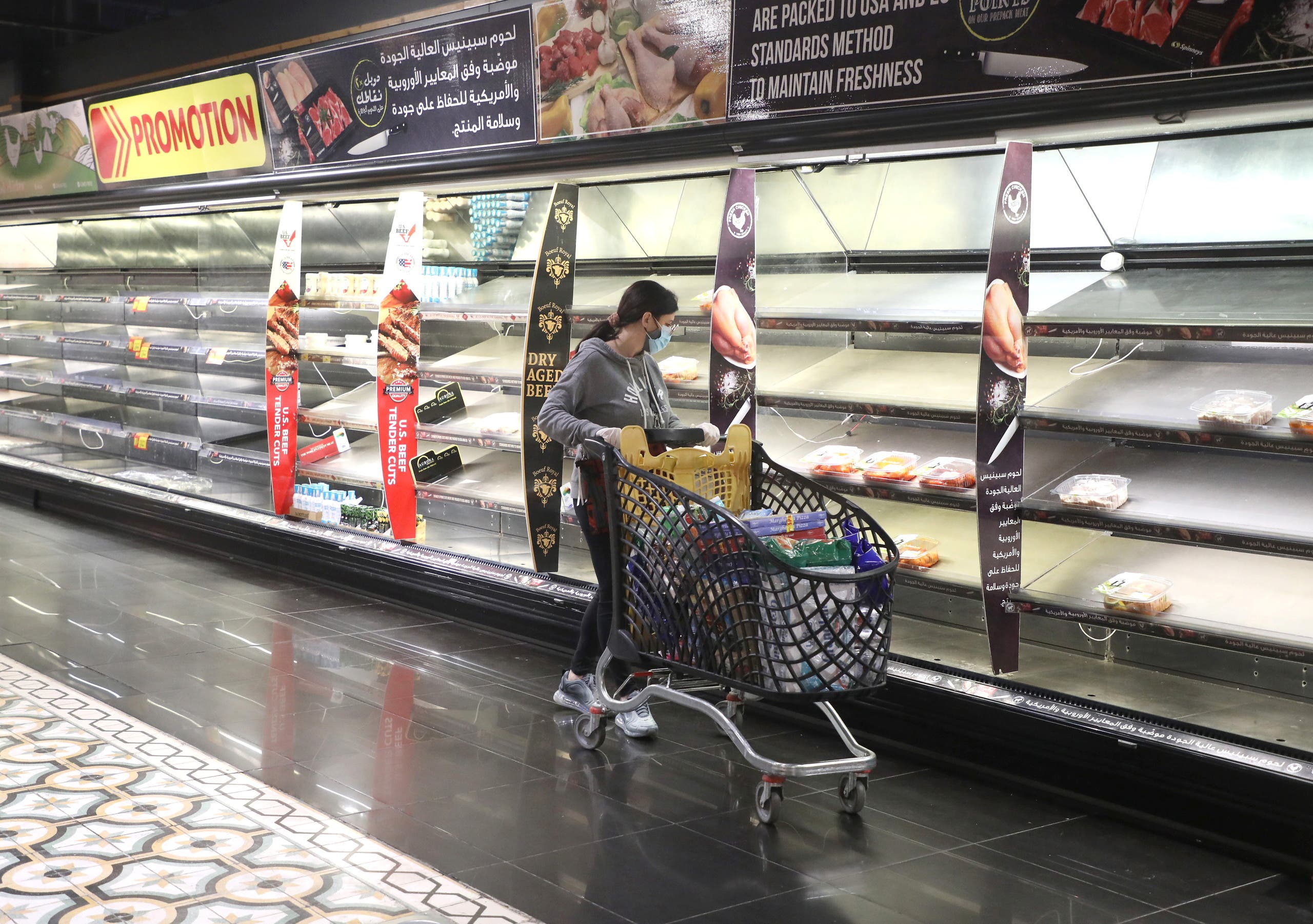 A customer pushes her trolley next to near empty shelves after people hoarded food as authorities are discussing the latest measures to implement to curb the spread of the coronavirus disease (COVID-19), in Beirut, Lebanon, January 11, 2021. (File photo: Reuters)