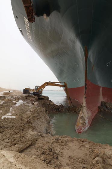 An excavator attempts to free stranded container ship Ever Given, one of the world's largest container ships, after it ran aground, in Suez Canal, Egypt March 25, 2021. (Reuters)