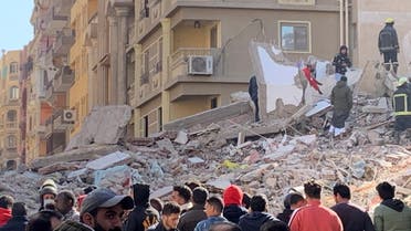 People inspect the area where a building was collapsed in Gesr al-Suez, Cairo. (Reuters)