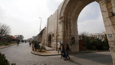 Syrians commute through Bab Sharqi (The Eastern Gate), one of the capital city's historic gates in Damascus' old town, on March 2, 2021. (AFP)