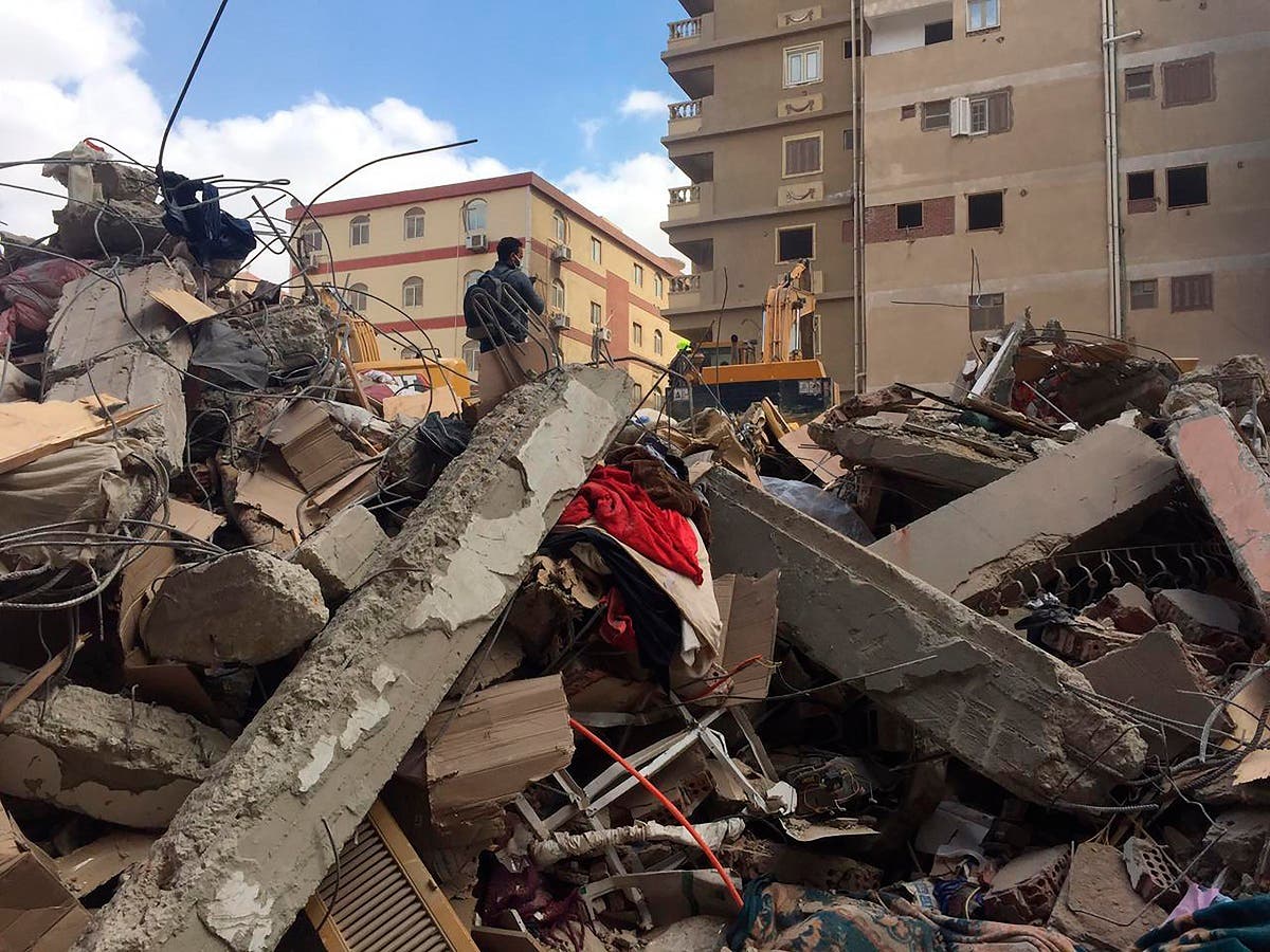 Emergency workers sift through the rubble of a collapsed apartment building in the el-Salam neighborhood, Saturday, March 27, 2021, in Cairo, Egypt. (AP)
