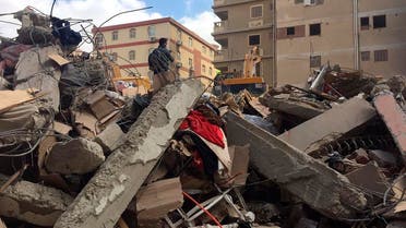 Emergency workers sift through the rubble of a collapsed apartment building in the el-Salam neighborhood, Saturday, March 27, 2021, in Cairo, Egypt. (AP)