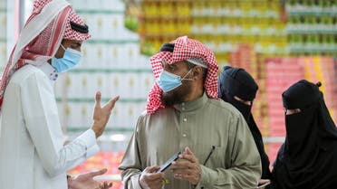 A man displays his details on his mobile phone using the Tawakkalna app, which was launched by Saudi authorities to track people infected with the coronavirus disease (COVID-19). (Reuters)