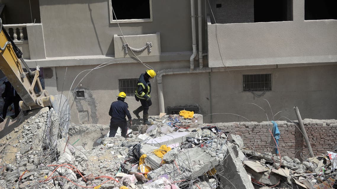 Rescurers work at the site where a building collapsed in Gesr al-Suez, Cairo, Egypt March 27, 2021. REUTERS/Shokry Hussien