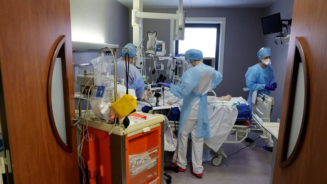 Medical staff work in the intensive care unit where coronavirus disease (COVID-19) patients are treated at Cambrai hospital, France, on March 25, 2021. (Reuters)