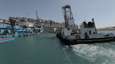 Dredgers attempt to free stranded ship Ever Given, one of the world's largest container ships, in Suez Canal. (Reuters)