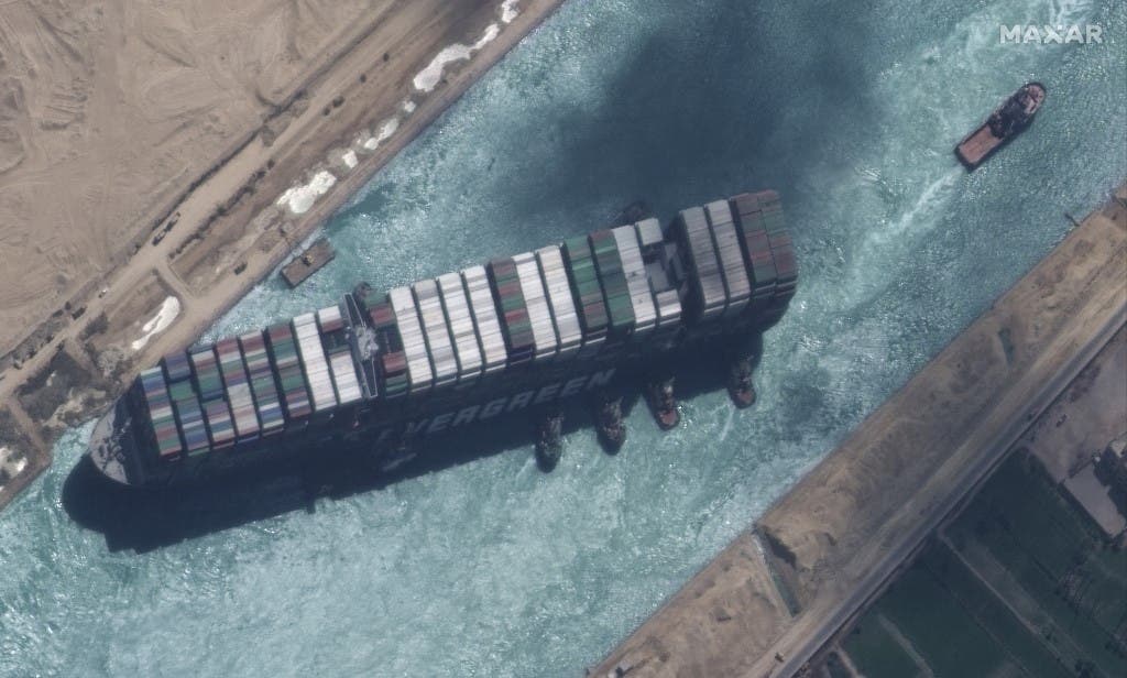 This satellite imagery released by Maxar Technologies shows a close up overview of the MV Ever Given container ship and tugboats in the Suez Canal on March 29, 2021. (AFP)