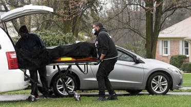 Workers wheel a gurney, with what police on the scene confirmed as a dead body, away from a home in Baldwin, Md., on Sunday, March 28, 2021. (AP)