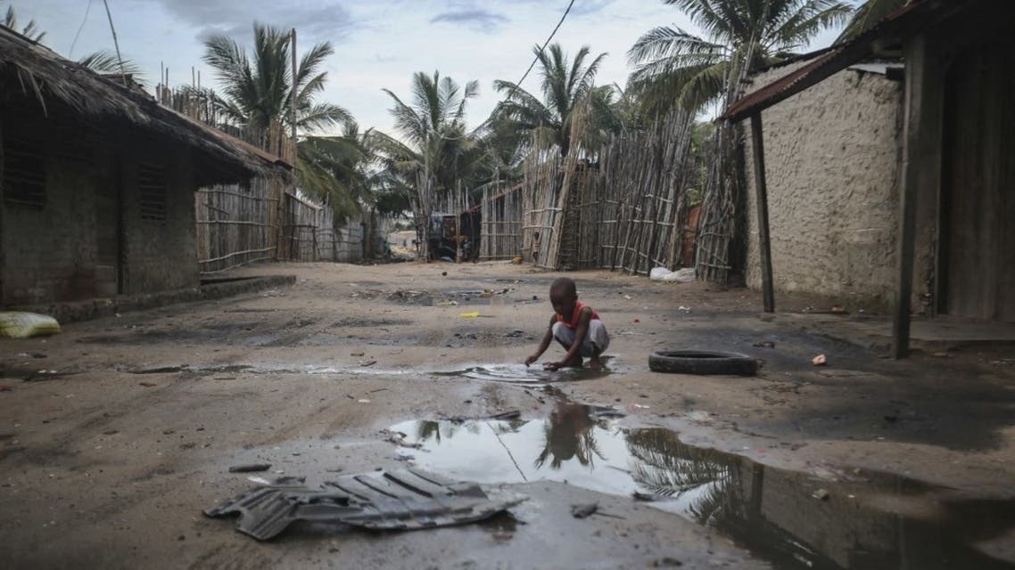 A child plays in one of the alleys of the port of Paquitequete near Pemba on March 29, 2021. (AFP)