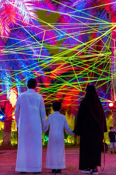 A Saudifamily enjoying Tom & Lien Dekyvere’s ‘Rhizome’ (2021) at the Palm Oasis in Riyadh. (Courtesy: Riyadh Art 2021)
