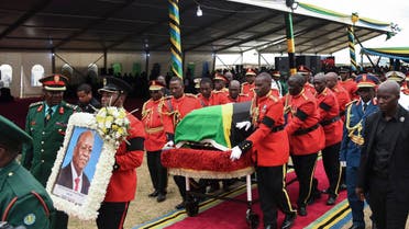 Personnel of the Tanzania People's Defence Force (TPDF) move the coffin of the late Tanzanian President John Magufuli for the burial after the farewell mass at Magufuli Stadium in Chato, Tanzania, on March 26, 2021. (AFP)