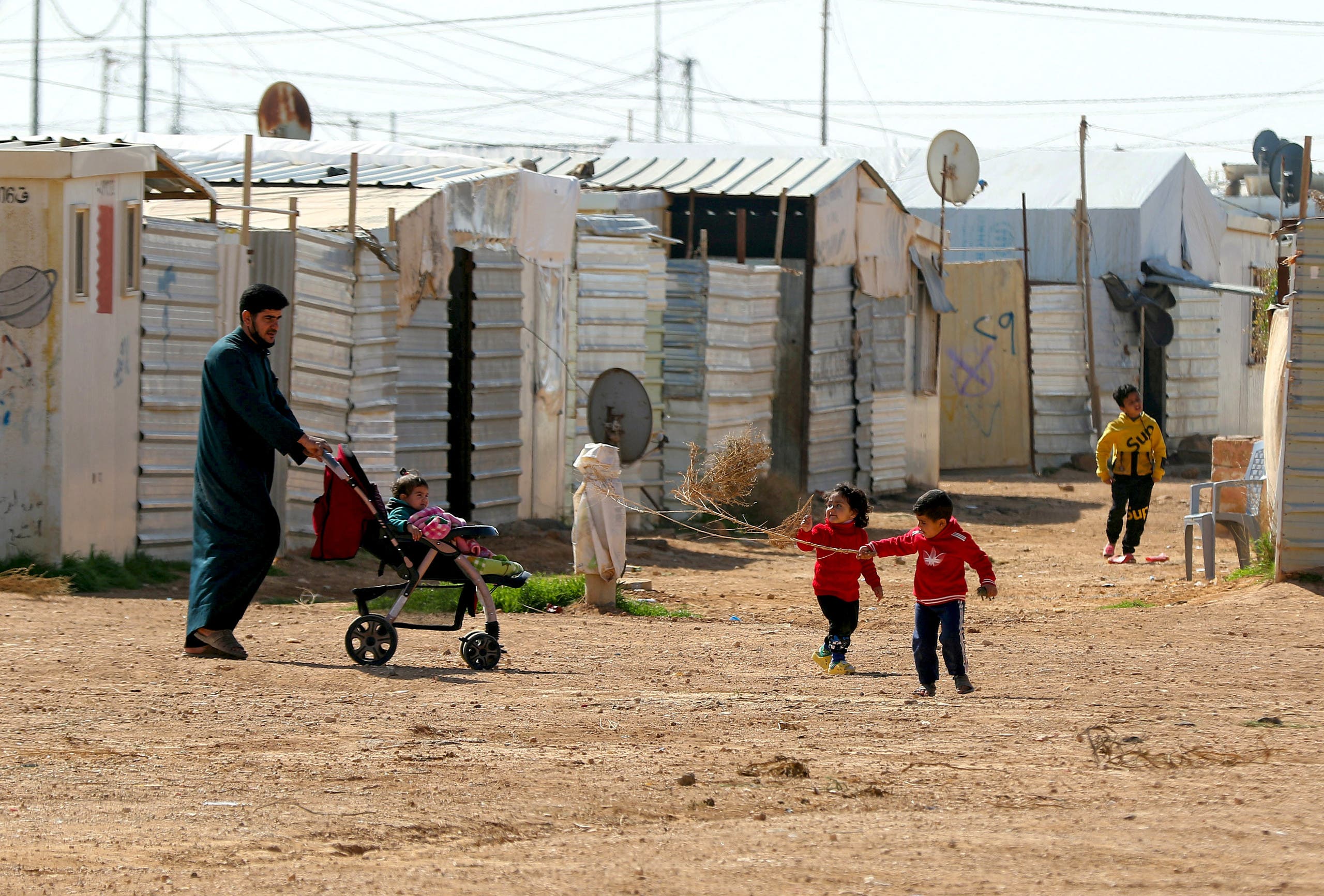 Syrian children play in the Zaatari refugee camp, 80 kilometers (50 miles) north of the Jordanian capital Amman on February 15, 2021.