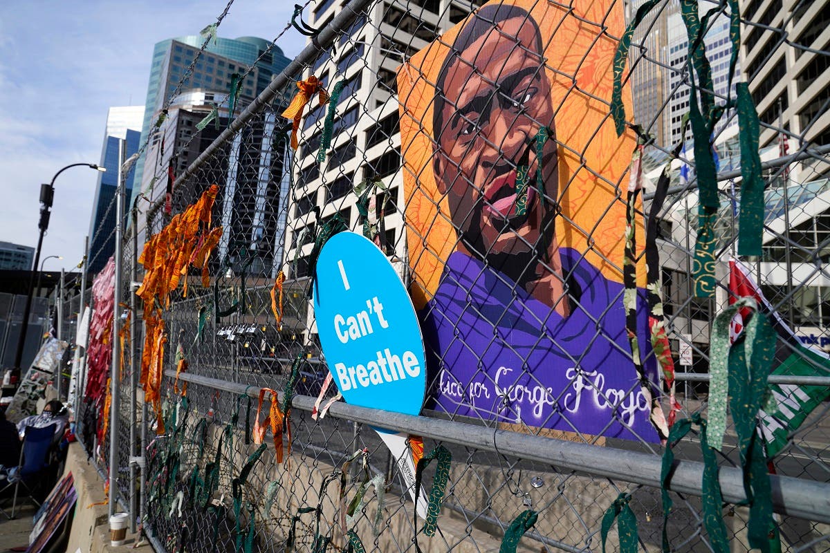 A picture of George Floyd hangs on a fence outside the Hennepin County Government Center, March 30, 2021, where the trial for former Minneapolis police officer Derek Chauvin continues. (AP)
